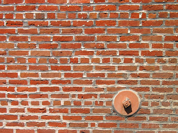 Brick wall with pipe stock photo