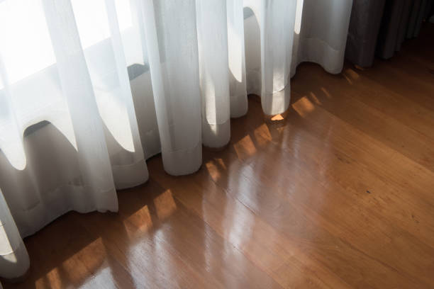 istock White curtains and brown wood floors 926961720