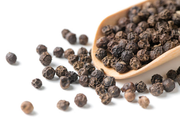 istock Dry black pepper on wood scoop isolated 926968410