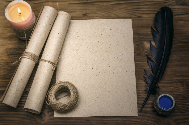 istock Empty blank paper page sheet with copy space, feather pen and inkstand  on wooden table background. Education background. Back to school. The ancient letter template. 926974890