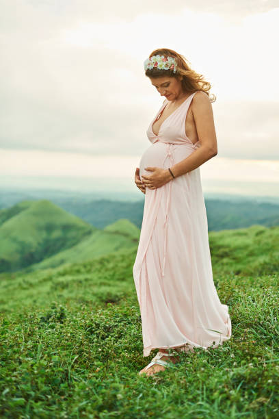 istock Pregnant woman stand on grass 926975030