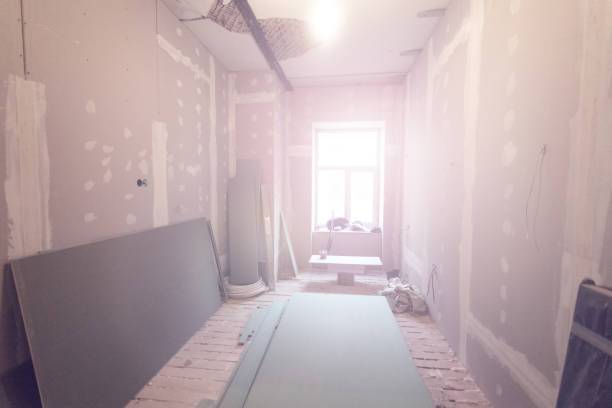 istock Working process of installing metal frames for plasterboard (drywall) for making gypsum walls  in apartment is under construction, remodeling, renovation, extension, restoration and reconstruction. 926978464