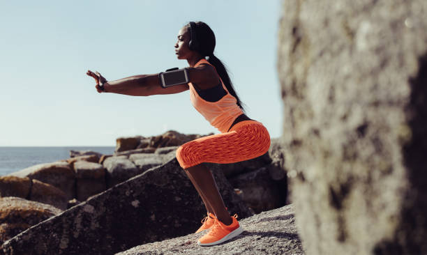 istock Healthy woman stretching at seaside rocks 926978576