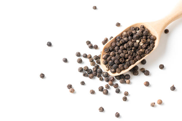 istock Dry black pepper on wood scoop isolated 926986060