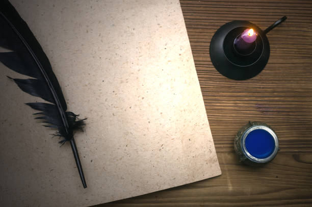 istock Blank paper page sheet with copy space and feather pen on wooden table surface. Education background with copy space. Author. Writer. Agreement. Contract. 926986234