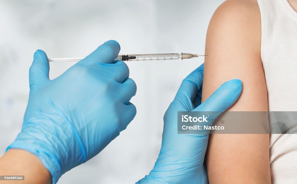 Medical vaccine Close up of doctor's hands vaccinating child Vaccination Stock Photo