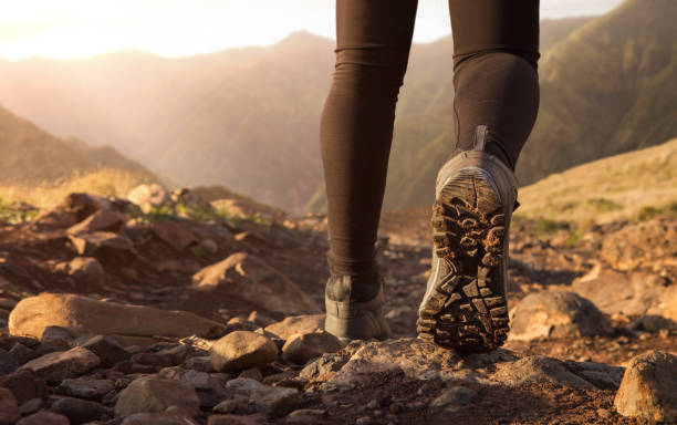 Hiking in the mountains Close up of hiker boots trekking in the mountains at the sunrise with copy space sole of shoe stock pictures, royalty-free photos & images