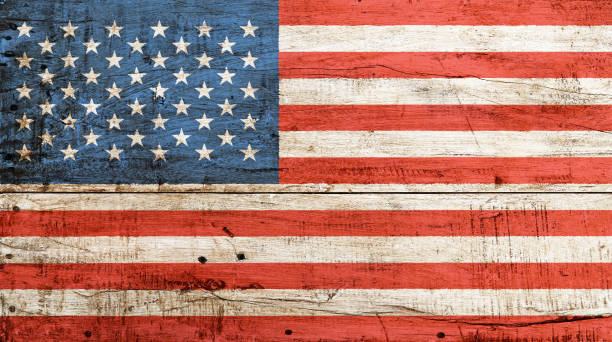 Old vintage American US flag over white wood