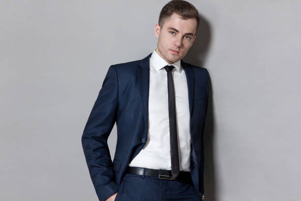 istock man in blue suit with vest in studio on gray background 927000120