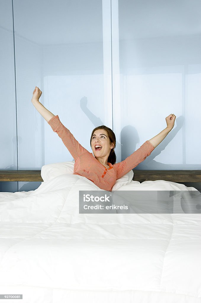 Happy waking up Portrait of a beautiful woman on a bed waking up Adult Stock Photo