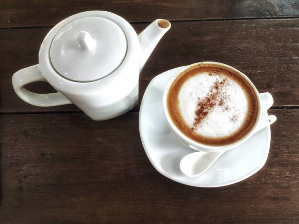 white cup of hot cappuccino coffee and white water crow for morning time, coffee break with soft background