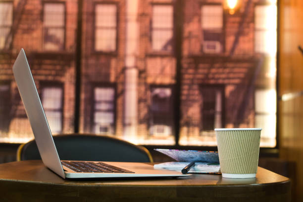 istock Coffee cup and laptop on the table in cafe 927005638