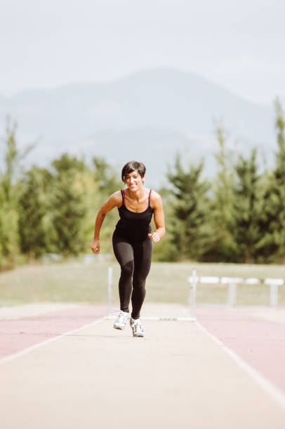istock woman running on the running track 927005950
