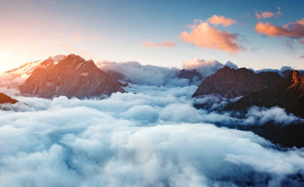 Creamy fog covered the famous glacier Marmolada. Location place Val di Fassa valley, passo Sella, Dolomiti, South Tyrol. Italy, Europe. Creamy fog covered the famous glacier Marmolada in morning light. Picturesque and gorgeous scene. Location place Val di Fassa valley, passo Sella, Dolomiti, South Tyrol. Italy, Europe. Beauty world. val stock pictures, royalty-free photos & images