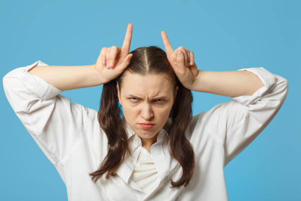 istock woman show horns 927009596