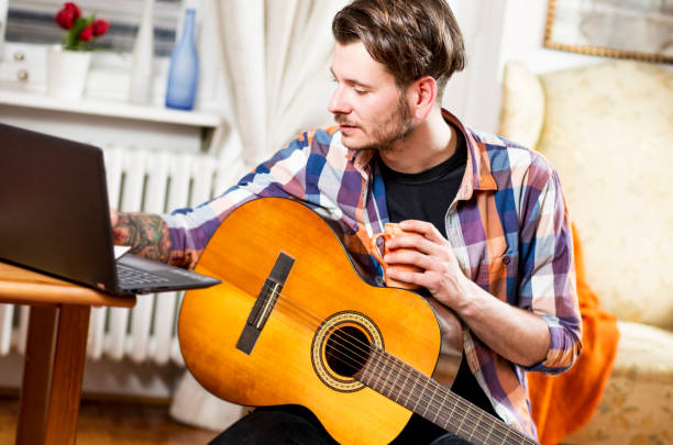 istock Young man musician, indoor. 927012460