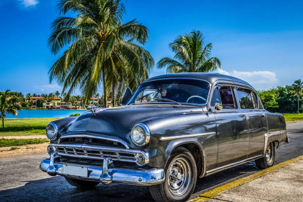 HDR - Black american black vintage car parked on the beach in Varadero Cuba stock photo