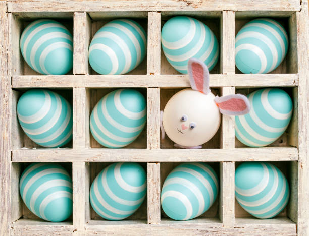 istock Easter Bunny and blue eggs in a wooden box - Background Spring Season Wood 927031896