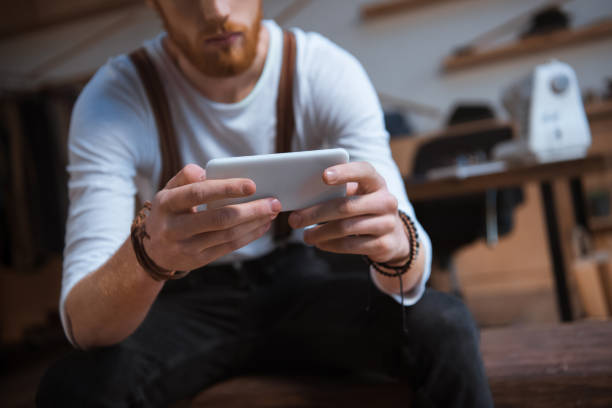 istock close-up view of stylish young man using smartphone 927038904