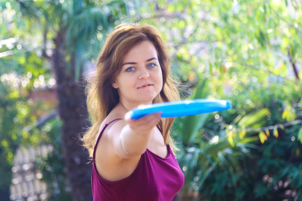 istock Young woman throwing a frisbee 927042678