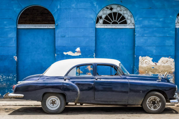 HDR - Cityscape with american black blue vintage car with white roof parked in on the street in Havana City Cuba - Serie Cuba Reportage stock photo