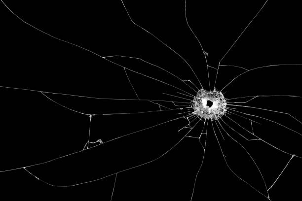 istock Bullet hole broken glass isolated on black background. Cut out. 927045564