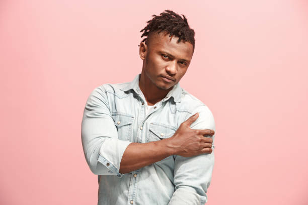 istock Young afro man overwhelmed with a pain in the shoulder 927047058