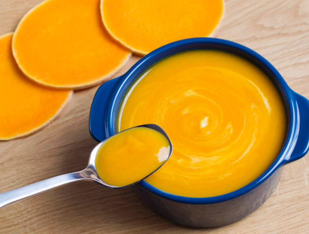 istock Pumpkin soup in a blue bowl and a spoon 927047188