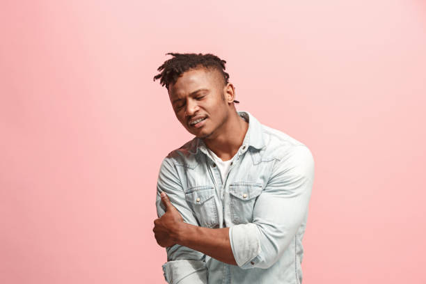 istock Young afro man overwhelmed with a pain in the shoulder 927047484