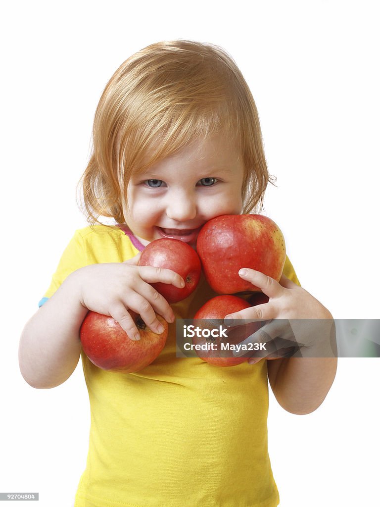 Little shy girl standing with her hands full of apples girl with apple  Apple - Fruit Stock Photo