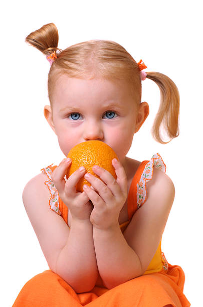 istock girl with orange isolated on white 92705199