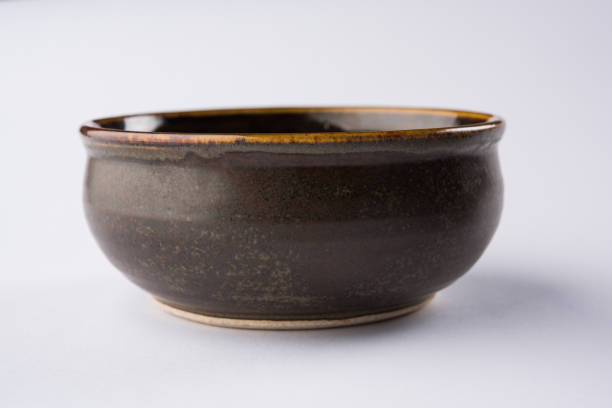 istock Empty brown ceramic serving bowl, isolated over white or gray background 927053858