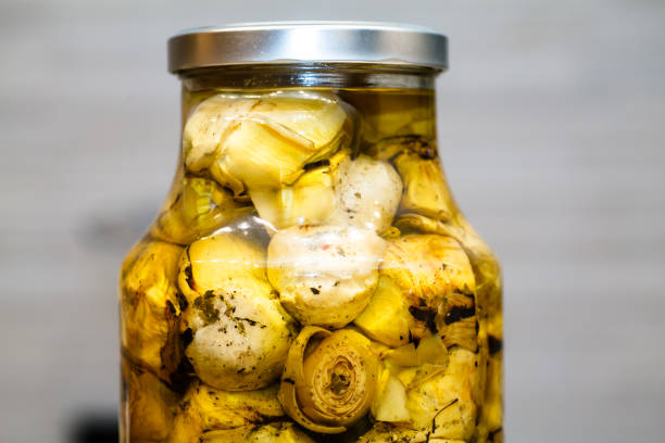 Glass jar with pickled artichokes