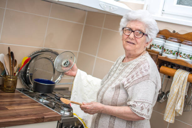istock Smiling grandmother cooking in the kitchen. 927056940