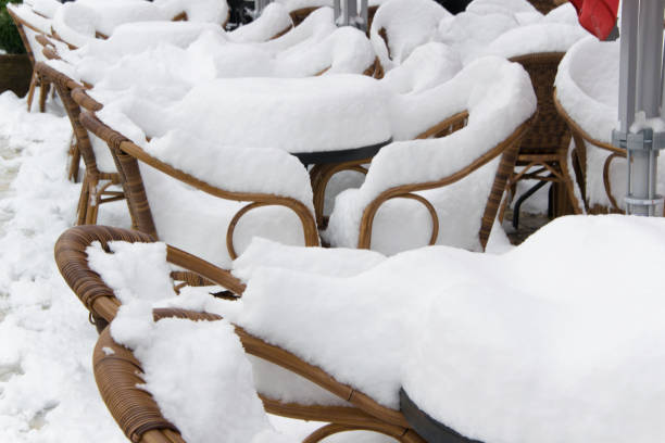 istock Tables and chairs of a cafe bar, covered with snow 927058336