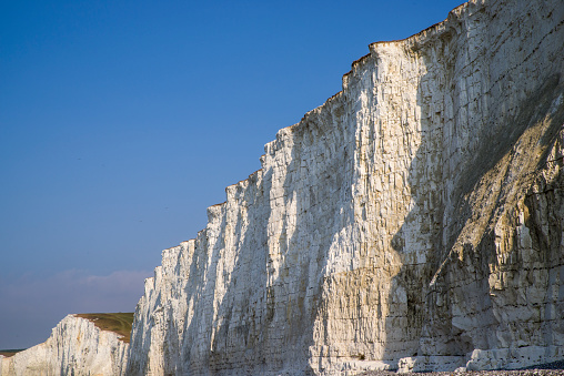 A view of the white cliffs that form part of the Seven Sisters coastline in East Sussex, UK.