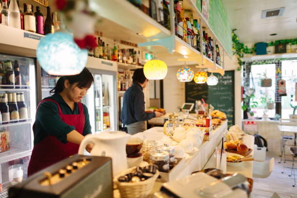 istock Waiter and waitress working behind cafe counter 927068374