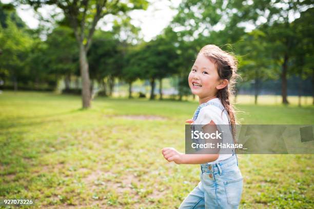 Little Girl Running While Laughing Stock Photo - Download Image Now - Child, Outdoors, Girls