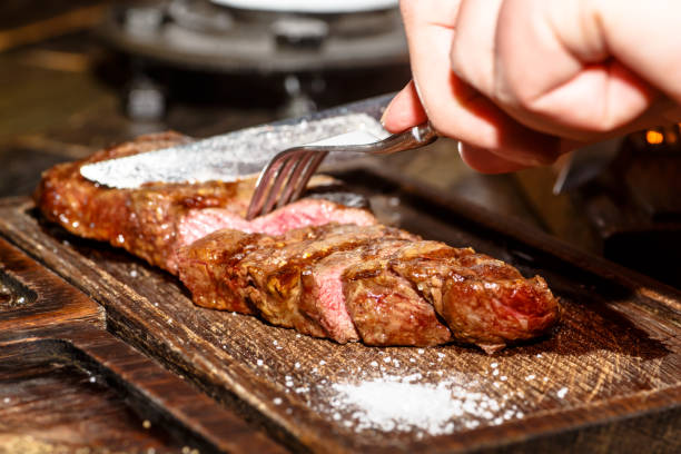 istock Beef steak ribeye and Striploin are on the Board and cut. 927074198