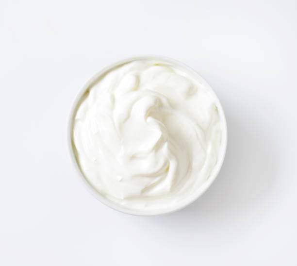 bowl of white cream bowl of white cream on white background cream cheese photos stock pictures, royalty-free photos & images