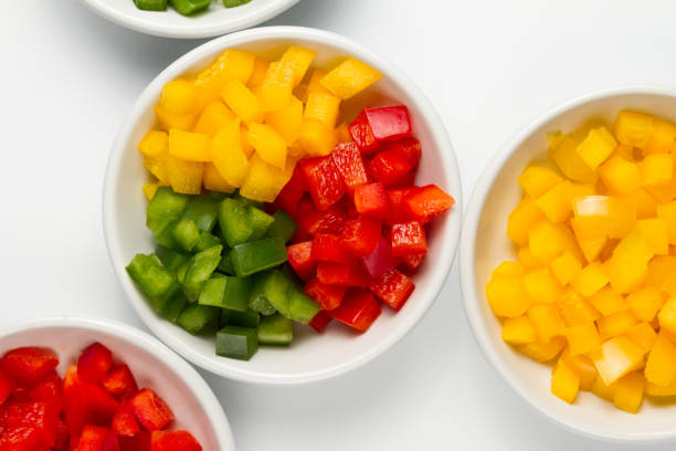istock Chopped 3 colors Bell pepper in white ceramic bowl 927077664