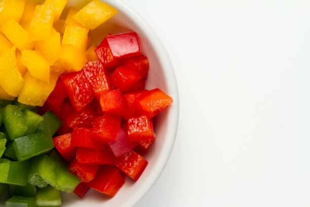 istock Chopped 3 colors Bell pepper in white ceramic bowl 927078764