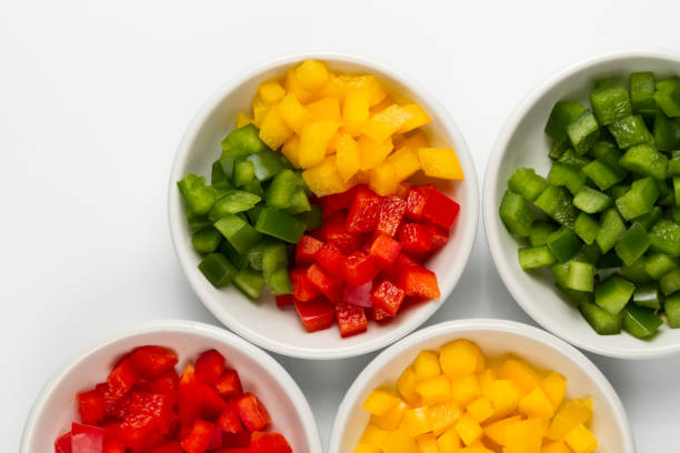 istock Chopped 3 colors Bell pepper in white ceramic bowl 927079348
