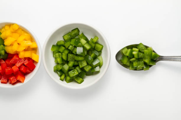 istock Chopped 3 colors Bell pepper in white ceramic bowl 927079696