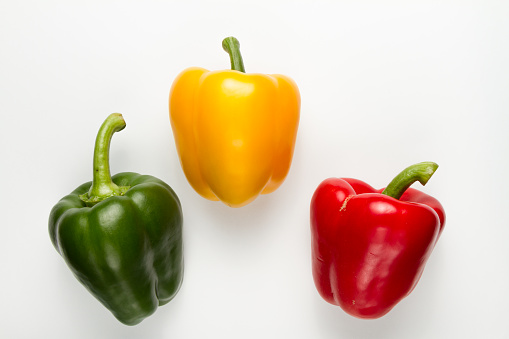 Variety of Bell peppers on white background.