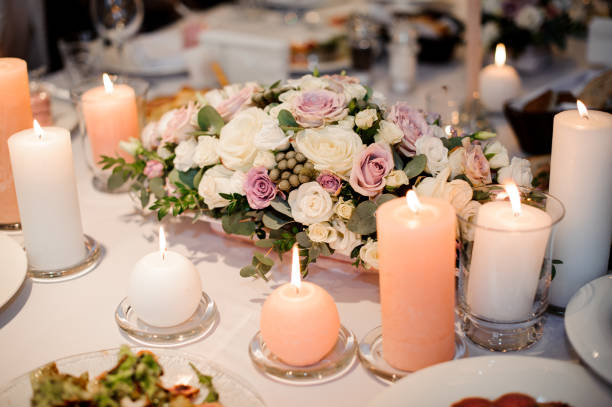 istock Beautiful flower composition and candles decorating a festive table 927079936