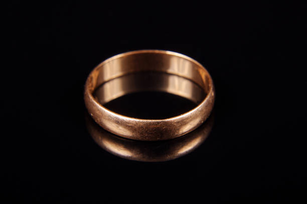 istock Scratched wedding ring isolated on the black background 927084074