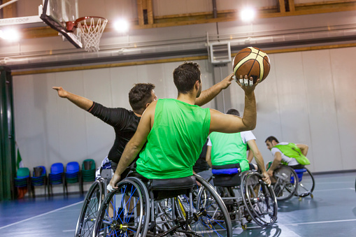 disabled sport men in action while playing indoor basketball at a basketball court