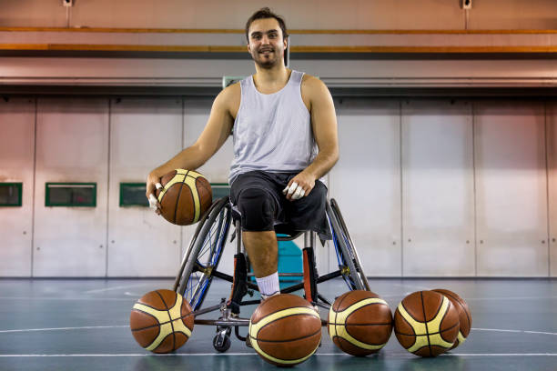 disabled sport men relaxation while playing indoor basketball at a basketball court