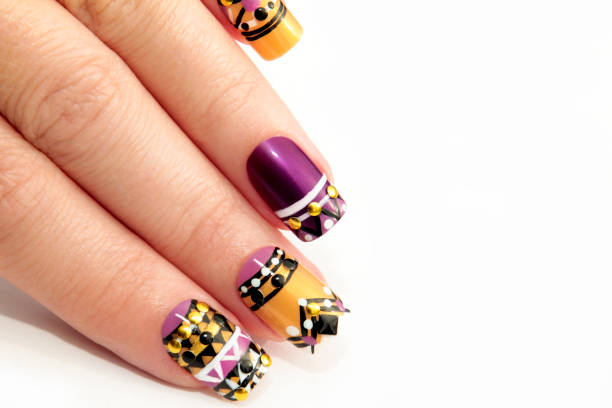Ethnic manicure. Multi-colored ethnic manicure on the nails close-up. yellow nail polish stock pictures, royalty-free photos & images